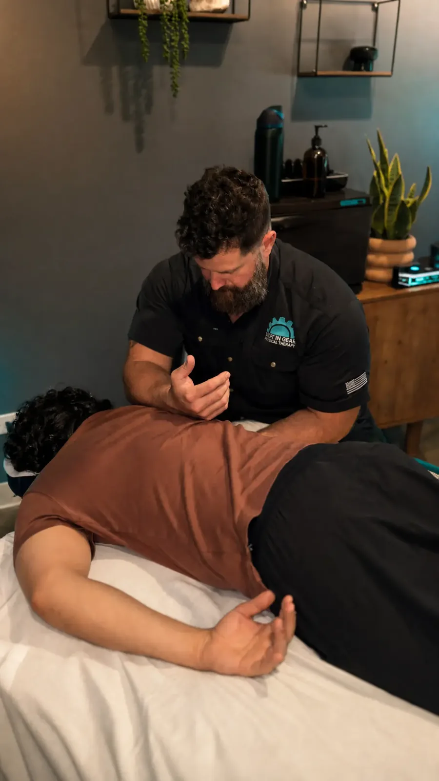 physical therapist conducting intake assessment before medical massage treatment